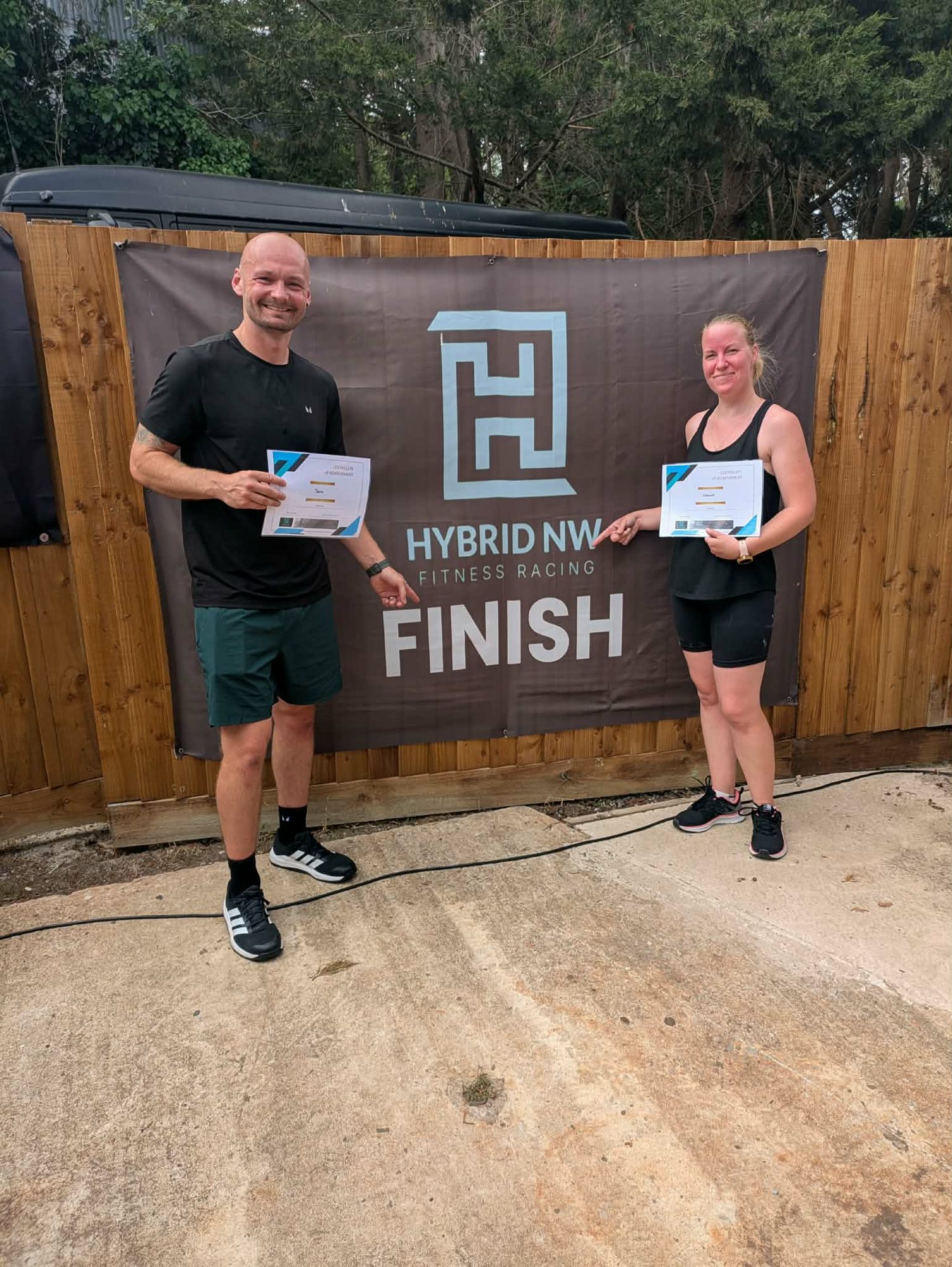 Members with certificates at the finish banner