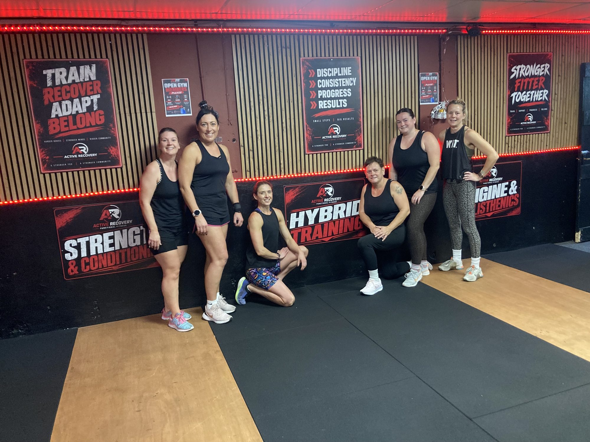 Members posing together in the gym